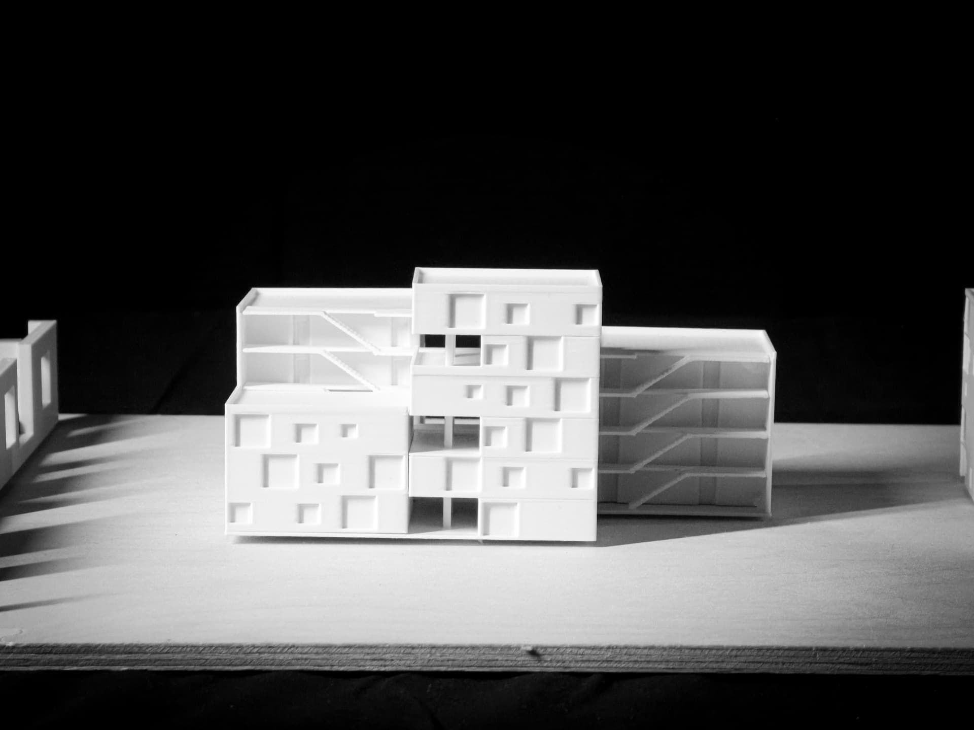 Sectional Study — White PLA sectional model revealing interior spatial relationships and circulation cores